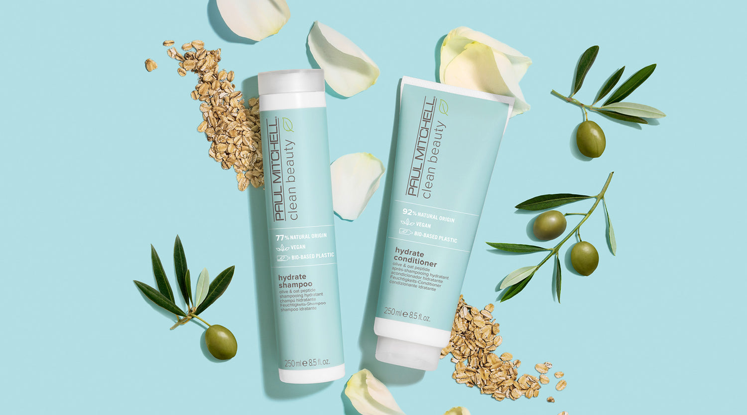 Produkte auf hellblauem Hintergrund mit Hafer, Rosenblättern und Oliven – Feuchtigkeitspflege für trockenes Haar.