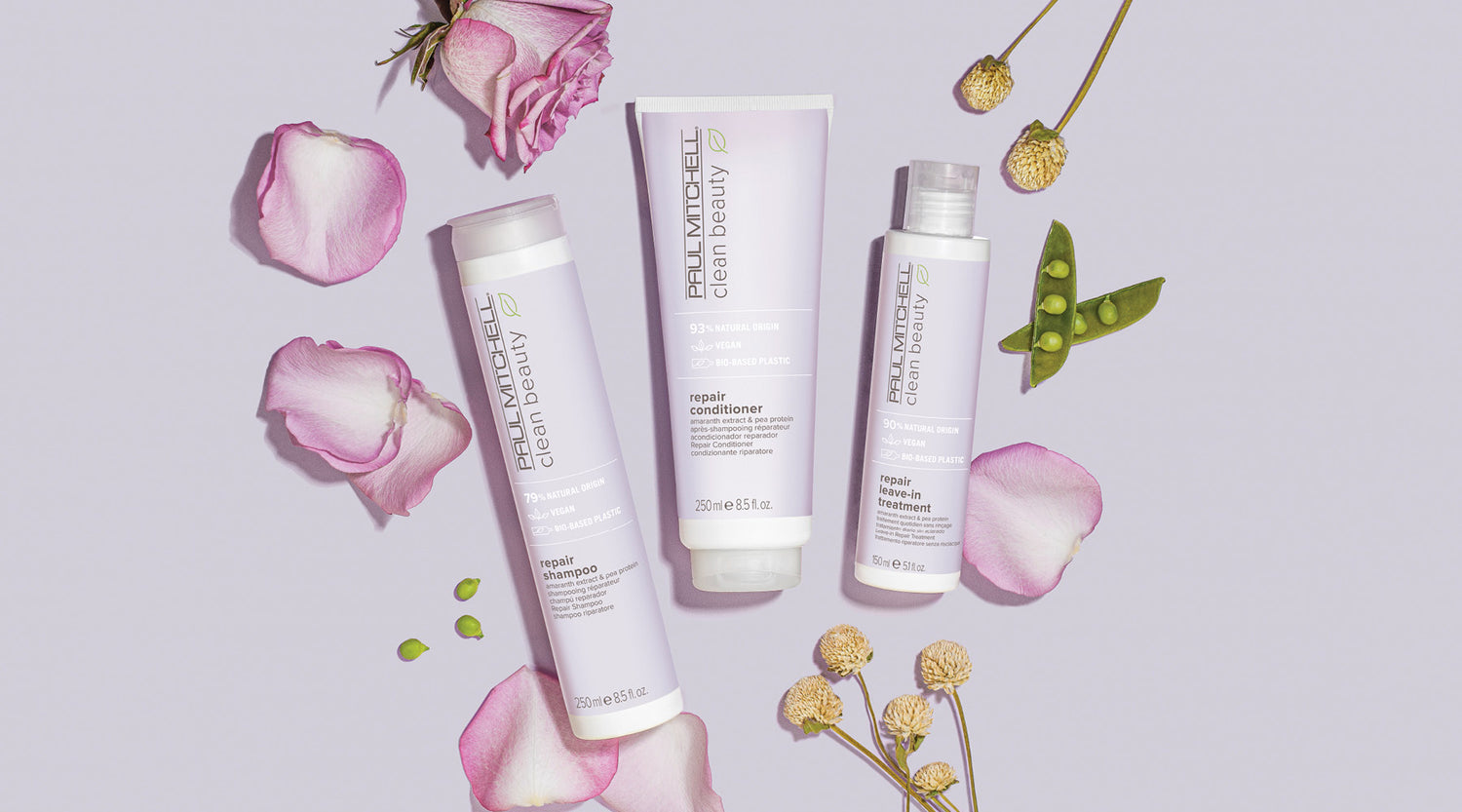 Haarpflege-Set auf rosa Hintergrund mit Blüten – für geschädigtes, brüchiges Haar.