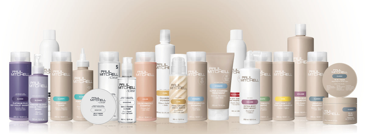 Paul Mitchell Produktreihe veganer Haarpflege- und Stylingprodukte nebeneinander vor beigem Hintergrund.