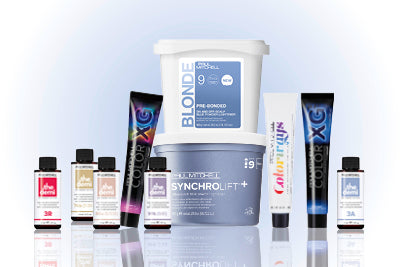 Paul Mitchell Farb- und Blondierprodukte nebeneinander vor hellem Hintergrund.